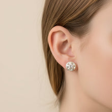 Load image into Gallery viewer, A single round stud earring with a white and black marbled pattern, shown next to its silver butterfly back on a textured blue background.
